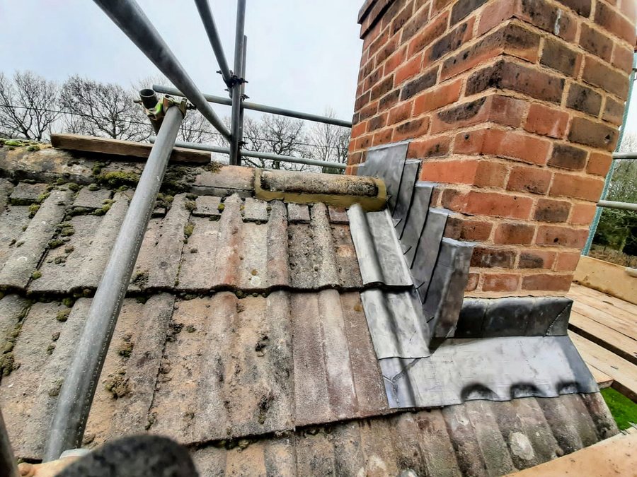 Stepped lead flashing and back gutter to a rebuilt chimney